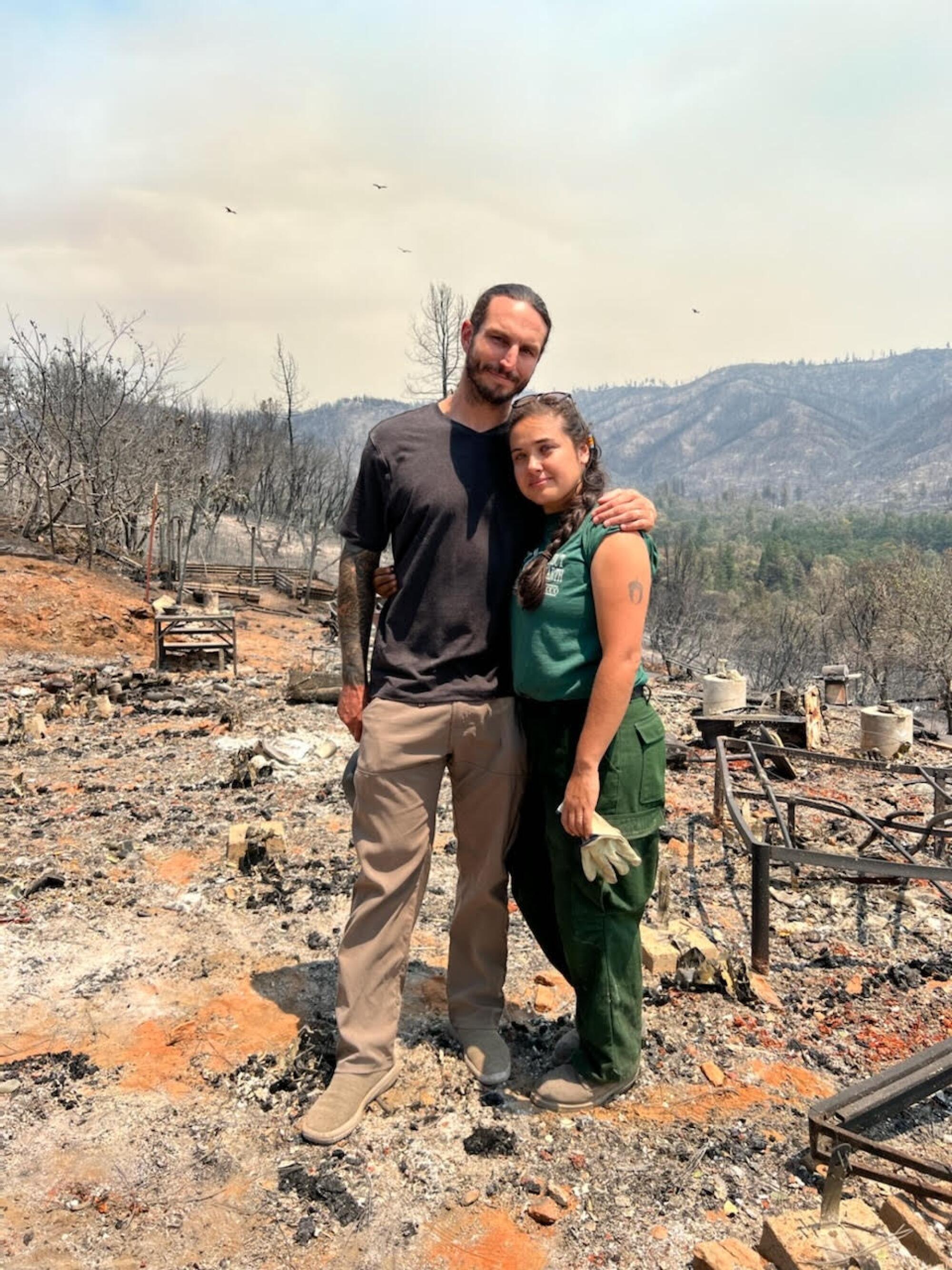 Irene Vasquez and husband Kevin Spach stand on the remains of their home.