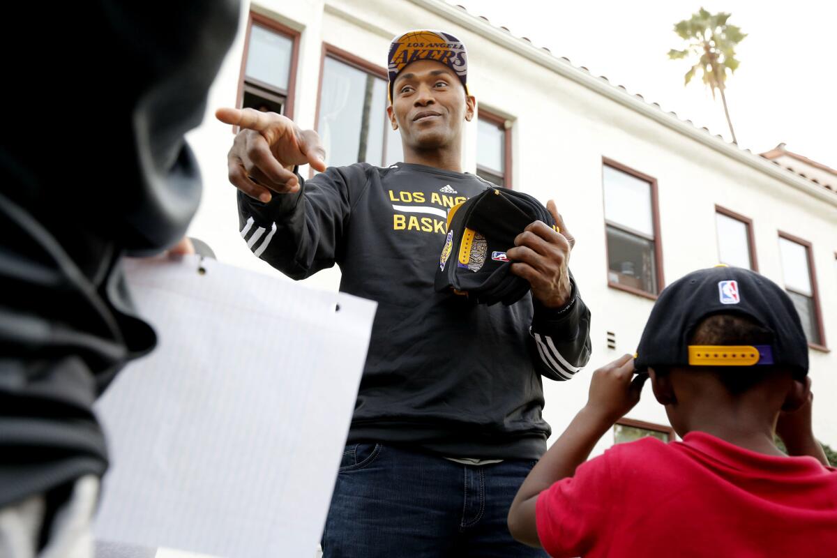 Lakers forward Metta World Peace visits the Door of Hope and its new basketball court.