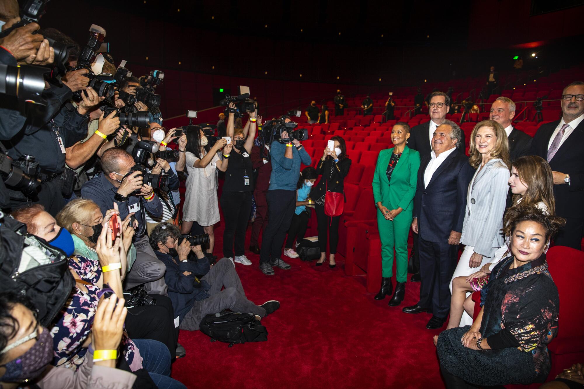 A gaggle of press, left, photograph posing press conference members