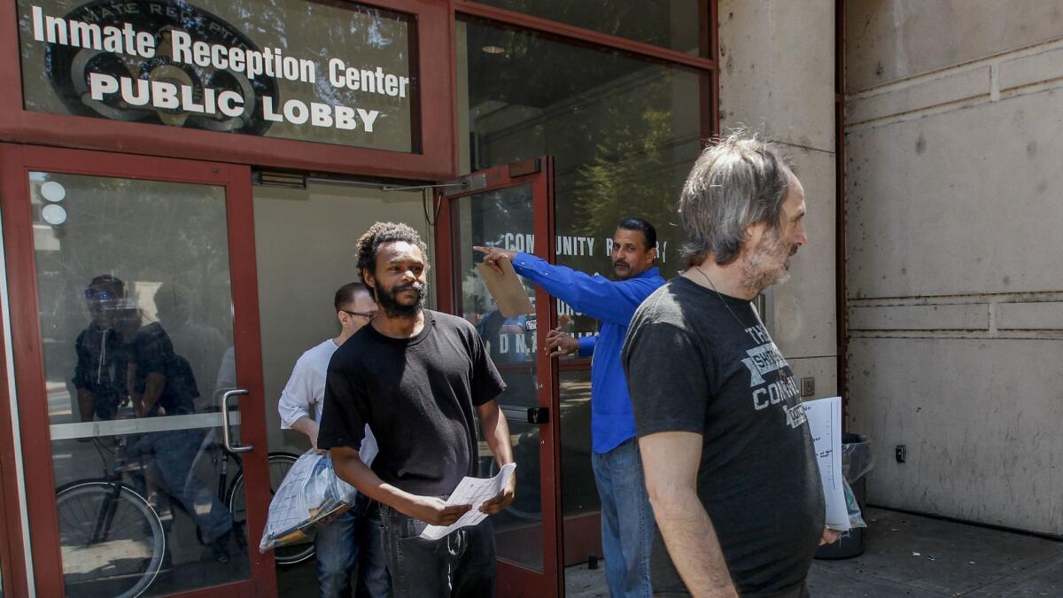 Aaron Float, left and Ellis Pickering are relased on probation from LA County Jail with Victor Key, case manager for Project 180, center, in blue shirt. The men agreed to enter an interim housing program.