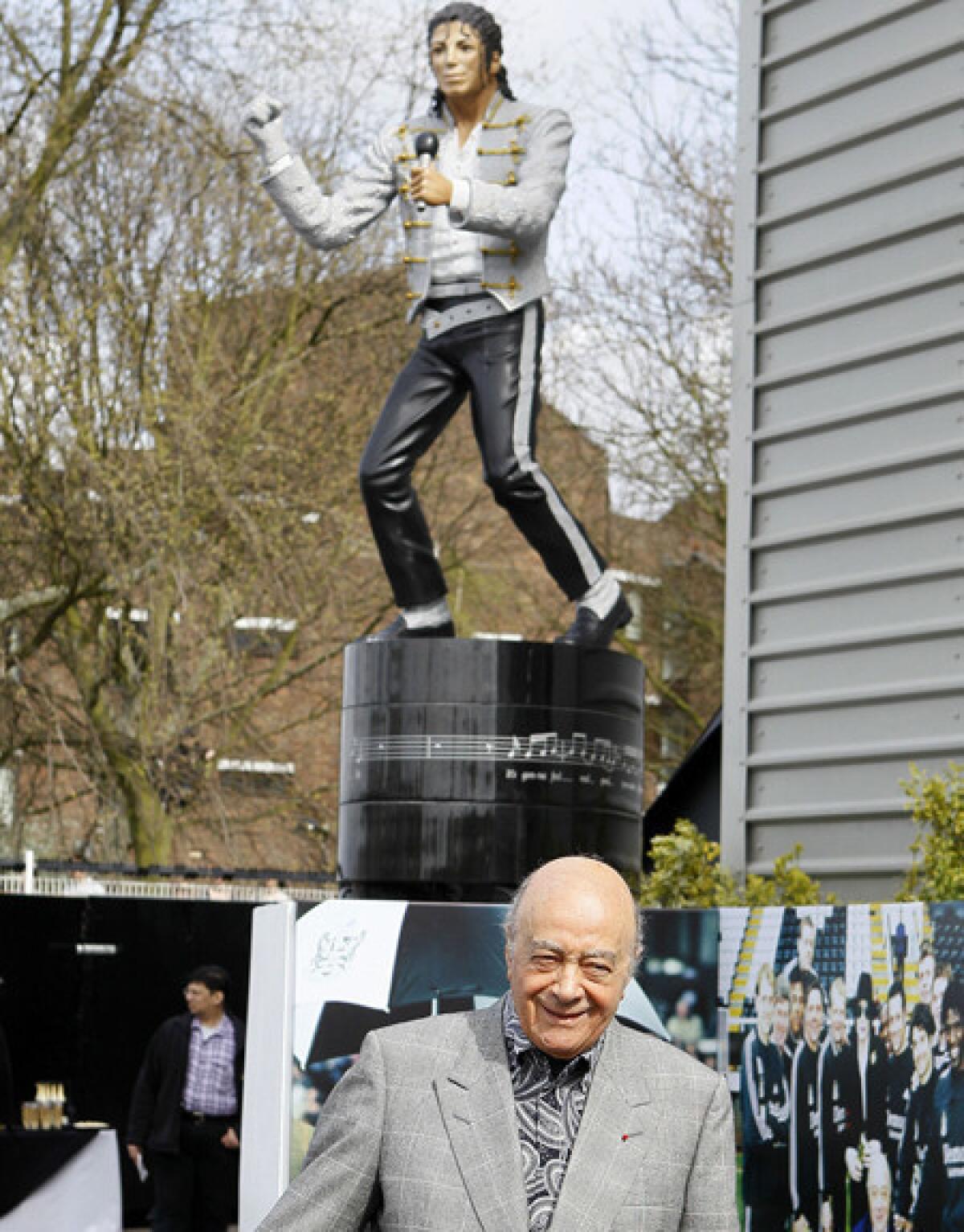 Fulham owner Mohamed Al Fayed is all smiles after unveiling a statue of Michael Jackson at the Craven Cottage Stadium grounds in London.
