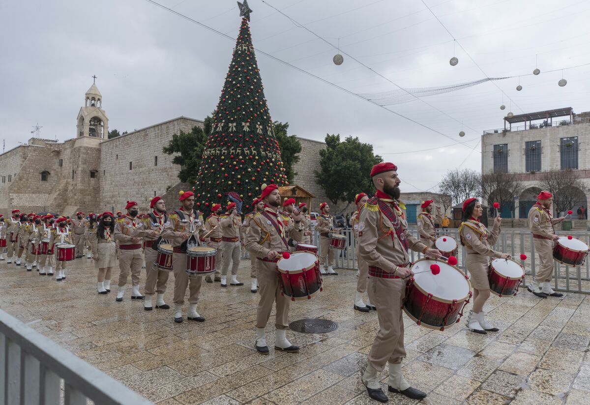 Palestinian scout bands parade through Manger Square at the Church of the Nativity in the West Bank city of Bethlehem 