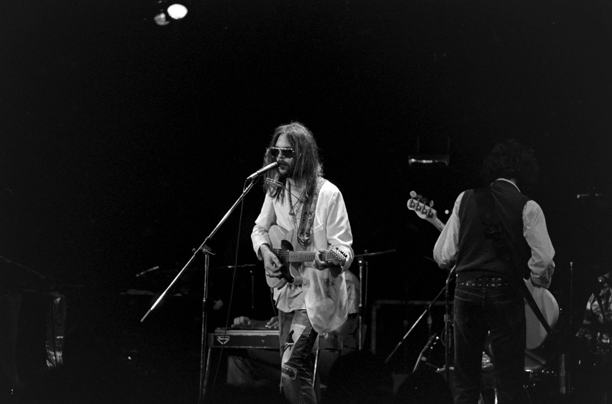 Neil Young performs onstage in 1973.