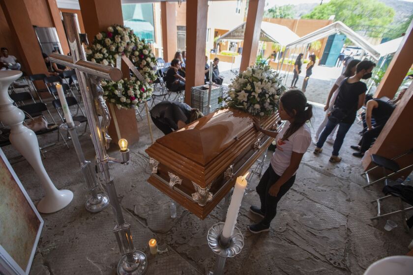 Friends and family mourn during the wake of mayoral candidate Alma Barragan in Moroleon, Mexico, Wednesday, May 26, 2021. Barragan was killed Tuesday while campaigning for the mayorship of the city of Moroleon, in violence-plagued Guanajuato state. (AP Photo/Armando Solis)
