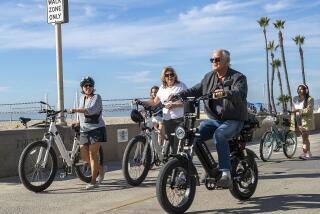 HERMOSA BEACH, CA-NOVEMBER 10, 2023, 2023:A man rides his e-bike on the Strand in Hermosa Beach as others walk their e-bikes in a walk only zone. In Hermosa Beach, it's against city code to use electric power on the Strand, but many e-bike riders do so anyway. (Mel Melcon / Los Angeles Times)