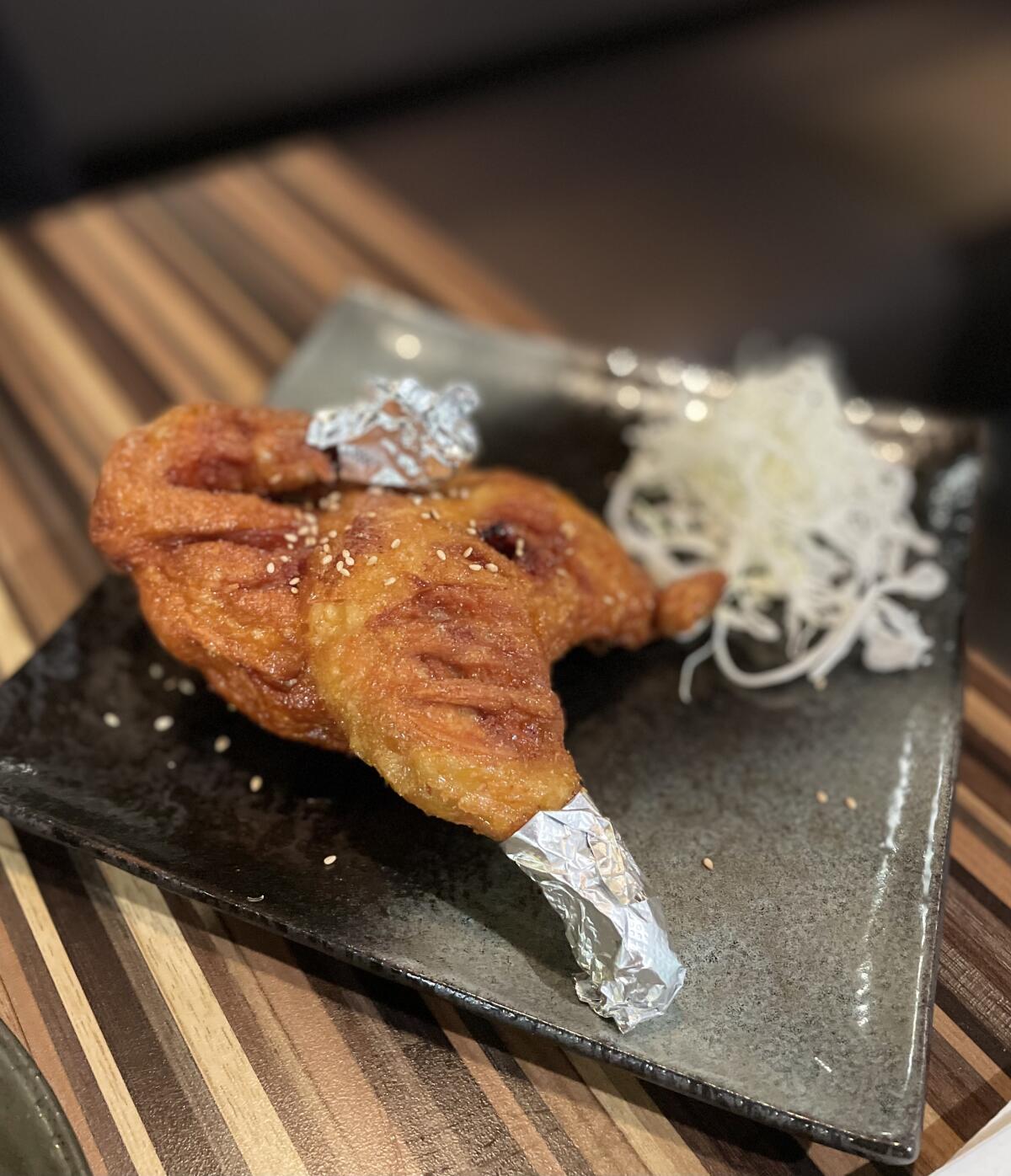 The "Tarzan" fried chicken at Furaibo in Santa Ana comes with foil on the tips of the wing and drumstick.