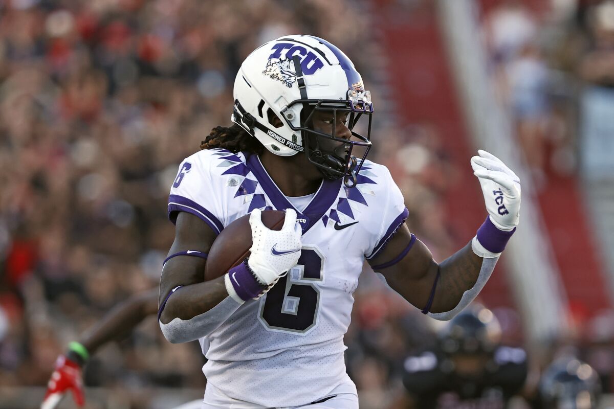 TCU's Zach Evans (6) runs with the ball during the first half of an NCAA college football game against Texas Tech, Saturday, Oct. 9, 2021, in Lubbock, Texas. (AP Photo/Brad Tollefson)