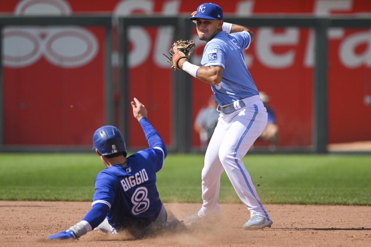 Kansas City Royals second baseman Nicky Lopez gets the force out on Toronto Blue Jays' Cavan Biggio at second, but couldn't make the play to first during the ninth inning of a baseball game, Wednesday, June 8, 2022, in Kansas City, Mo. (AP Photo/Reed Hoffmann)