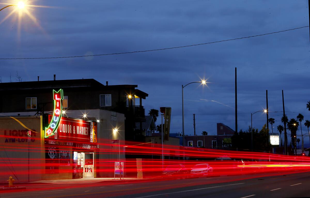 Car taillights appear as red streaks in a timed-exposure photo of Figueroa Street in South Los Angeles 