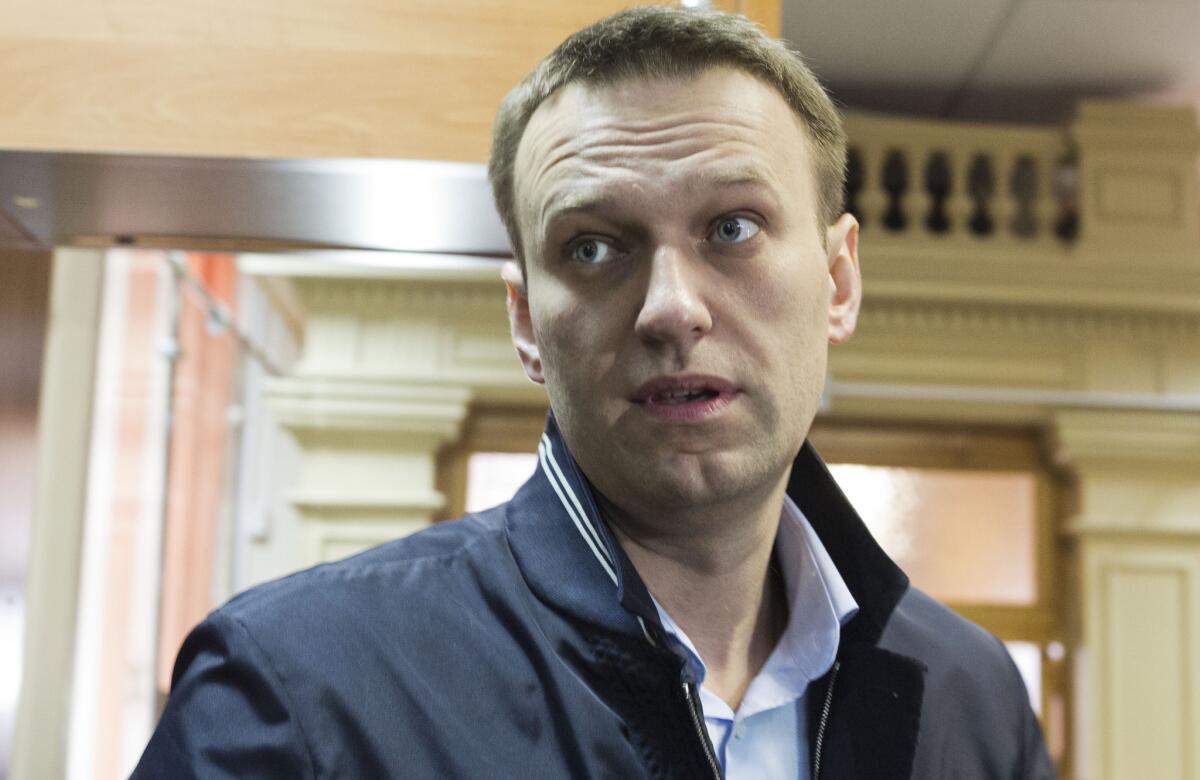 Russian opposition leader Alexei Navalny enters a courtroom in Kirov, Russia. Navalny is accused of embezzlement, but says the case is politically motivated.