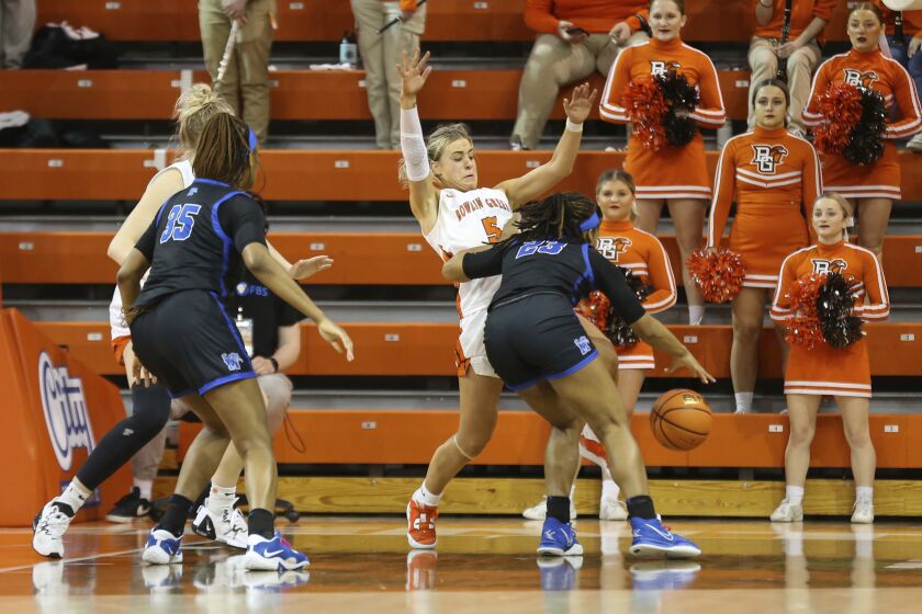 Bowling Green guard Elissa Brett (5) draws a charging foul against Memphis guard Jamirah Shutes (23) during the second half of a WNIT game aat the Stroh Center in Bowling Green, Ohio, Friday March 23, 2023. (Scott Grau/Sentinel-Tribune via AP)