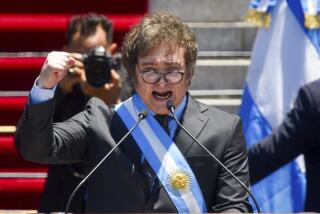 Argentina's newly sworn-in President Javier Milei speaks outside the Congress in Buenos Aires, Argentina, Sunday, Dec. 10, 2023. (AP Photo/Gustavo Garello)