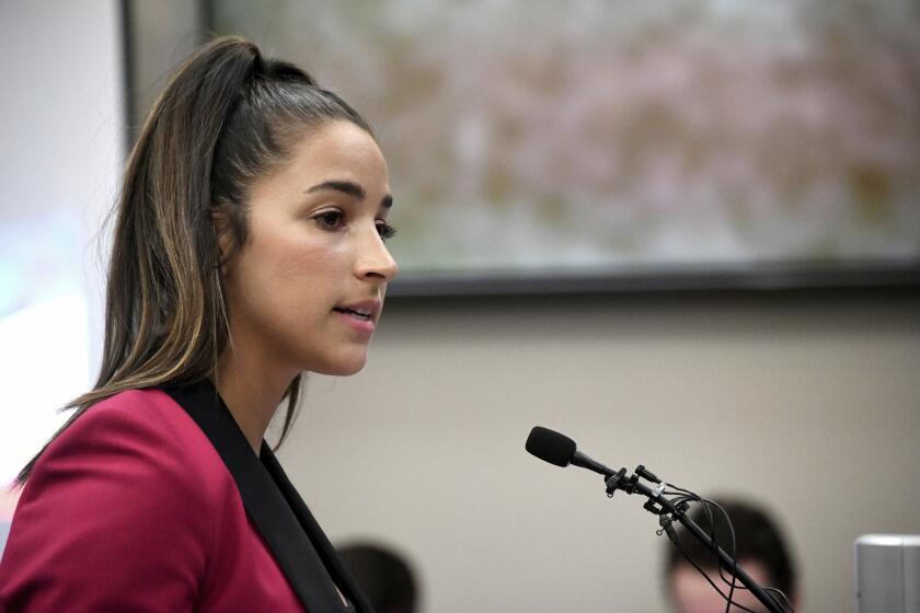 FILE- In this Jan. 19, 2018, file photo, Olympic gold medalist Aly Raisman gives her victim impact statement in Lansing, Mich., during the fourth day of sentencing for former sports doctor Larry Nassar, who pled guilty to multiple counts of sexual assault. Six-time Olympic medalist Aly Raisman is suing the U.S. Olympic Committee and USA Gymnastics, claiming both organizations "knew or should have known" about abusive patterns by a disgraced former national team doctor now in prison for sexually abusing young athletes.Raisman filed the lawsuit in California on Wednesday, Feb. 28, 2018. (Dale G. Young/Detroit News via AP, File)