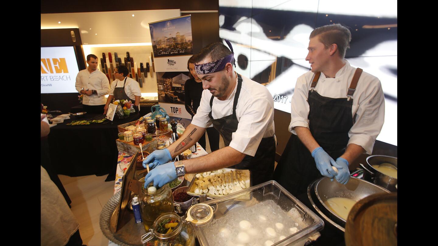 Jad Elsayed, left, and Ben Minick, from the Cucina Enoteca restaurant team, create mozzarella combo bites during the Newport Beach Restaurant Week media preview party at the Lincoln Center Experience in Fashion Island on Thursday.