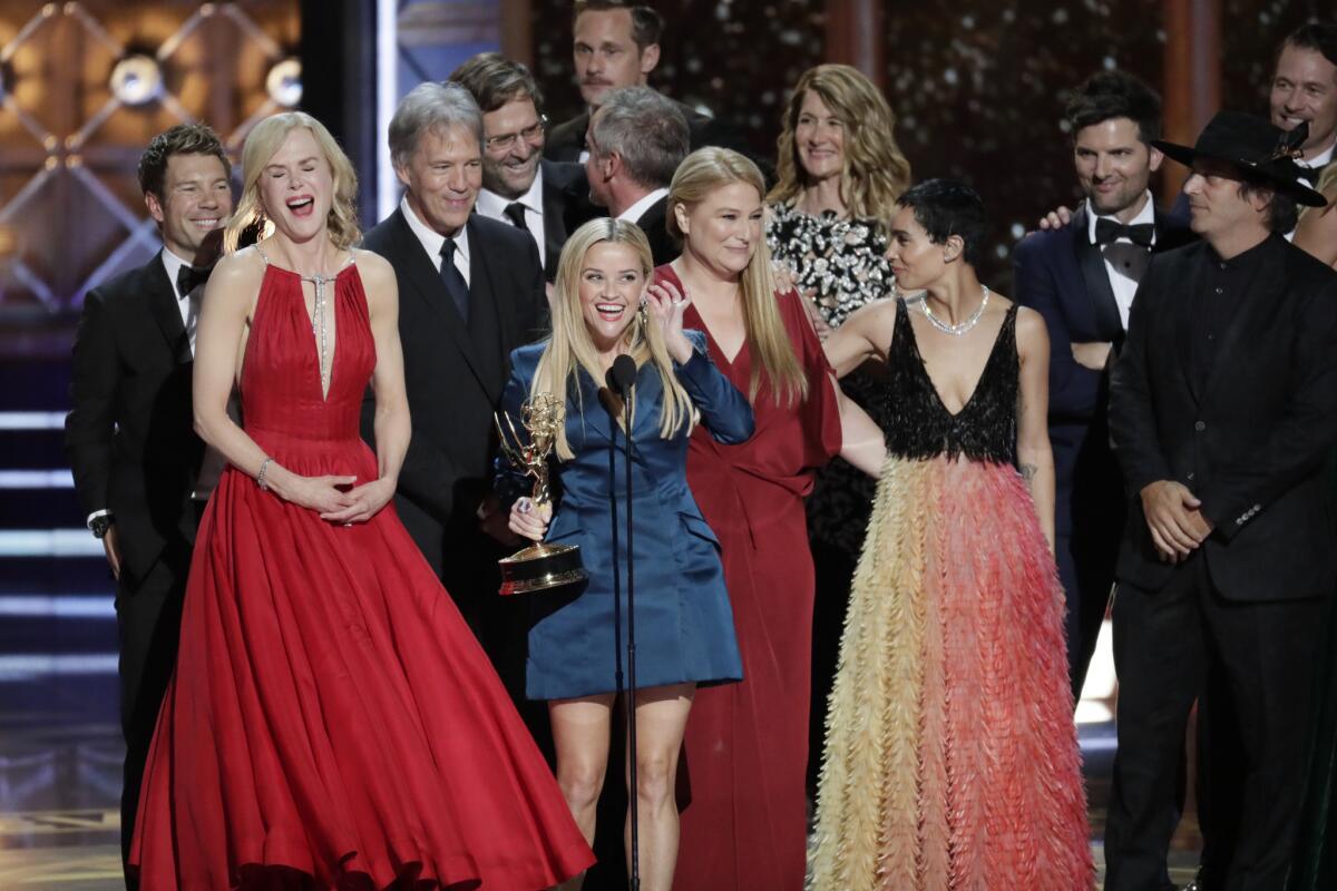 Reese Witherspoon, center, accepts the outstanding limited series Emmy for "Big Little Lies," surrounded by the show's cast and creative team at the 69th Emmy Awards in Los Angeles.