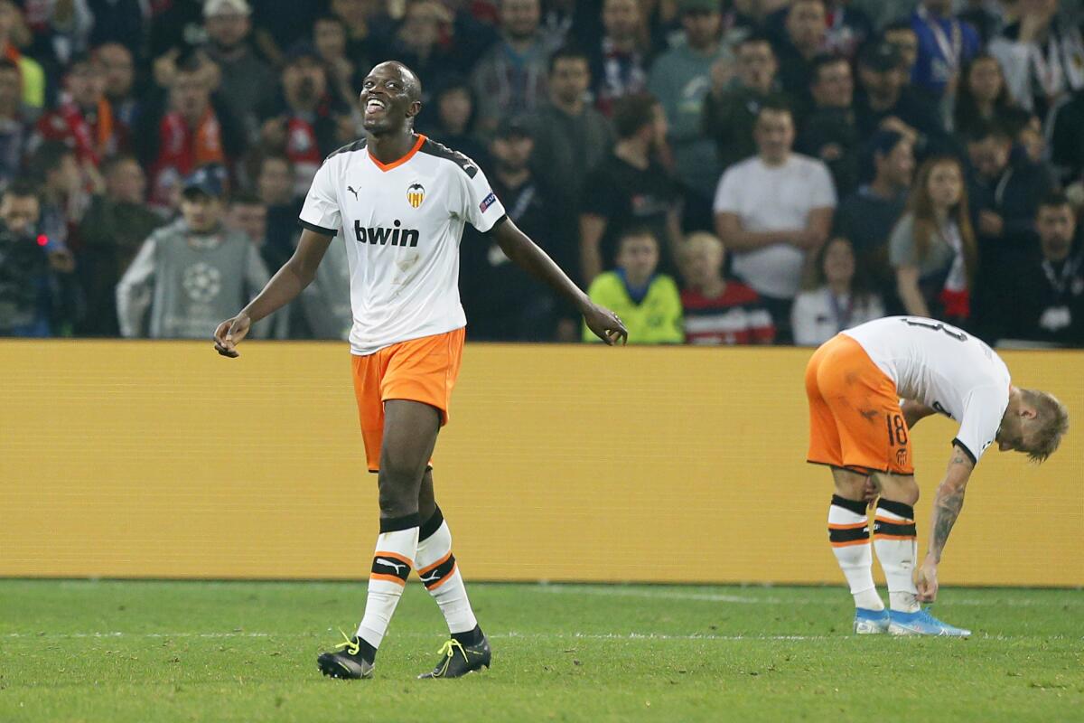 FILE - In this Oct. 23, 2019, file photo, Valencia's Mouctar Diakhaby, left, leaves the pitch after receiving a red card during the group H Champions League soccer match between Lille and Valencia at the Stade Pierre Mauroy - Villeneuve d'Ascq stadium in Lille, France. Valencia stopped playing its Spanish league game at Cadiz on Sunday, April 4, 2021 and walked off the field after one of its players said he was racially insulted by an opponent. The club said it resumed the game after feeling threatened by the referee with the loss of points. Valencia left the field after Diakhaby said he was insulted by Cadiz defender Juan Cala, who denied any wrongdoing. Cadiz, from southern Spain, condemned racism but said it "cannot comment on incidents that arise between players during the course of play.” (AP Photo/Michel Spingler, File)