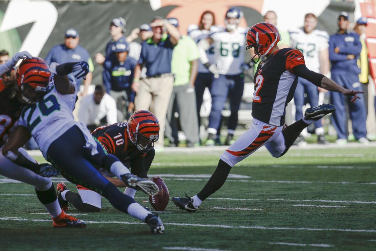 Cincinnati's Mike Nugent kicks the game-winning field goal against Seattle on Sunday.