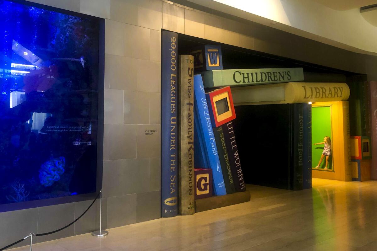 A photograph of human-sized books at Cerritos Library.