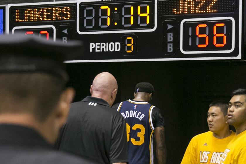 Utah Jazz forward Trevor Booker (33) leaves the floor after being ejected from a game against the Lakers after an altercation with Lakers center Roy Hibbert.