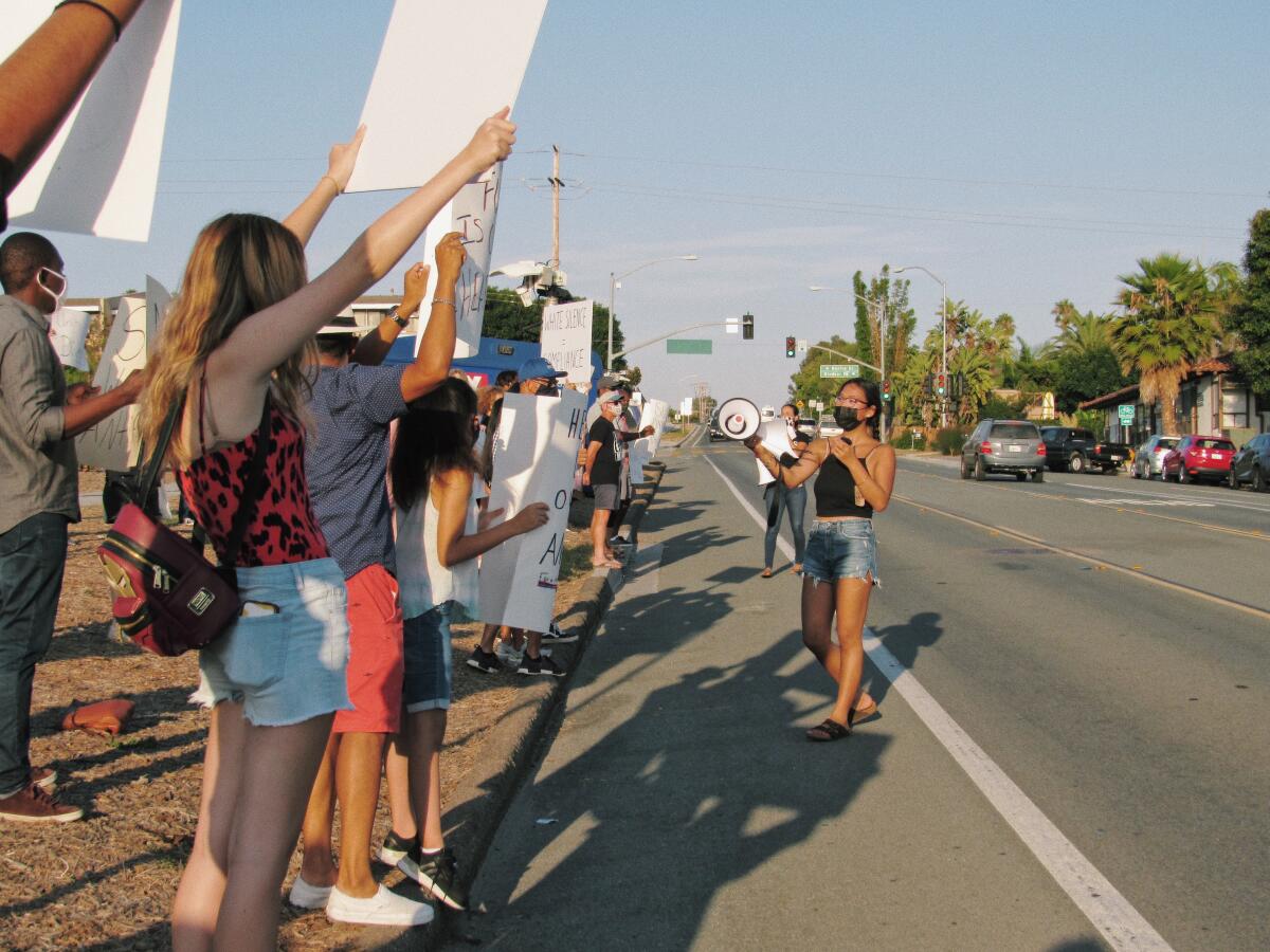 Joy Ruppert (holding bullhorn) leads a peaceful protest at San Dieguito Academy 