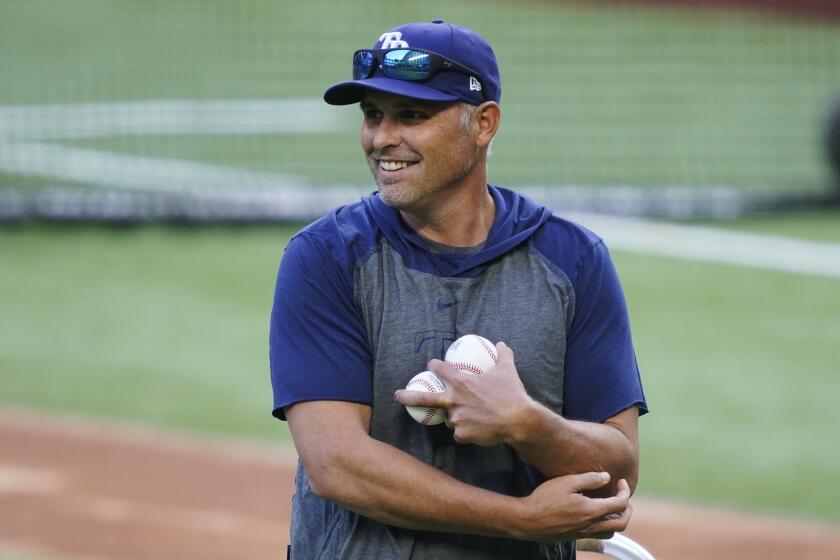 Tampa Bay Rays manager Kevin Cash throws batting practice before Game 1 of the baseball World Series Series against the Los Angeles Dodgers Tuesday, Oct. 20, 2020, in Arlington, Texas. (AP Photo/Tony Gutierrez)