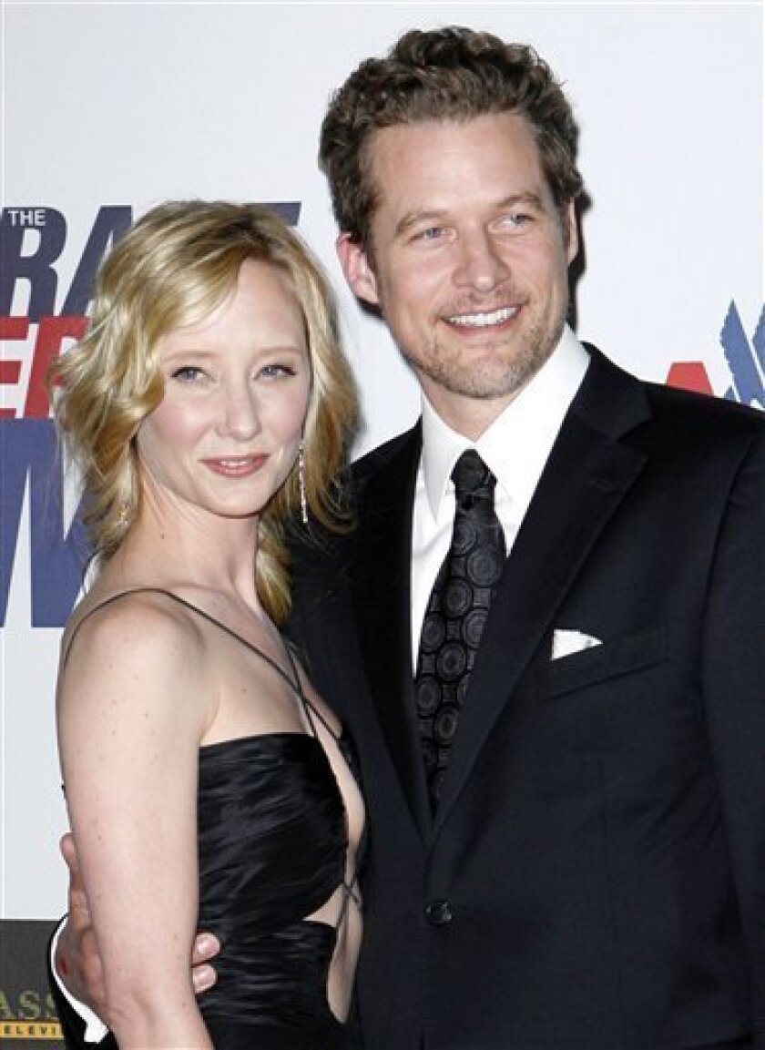 In this May 2, 2008 file photo, Anne Heche and James Tupper arrive at the 15th annual Race to Erase event in Los Angeles. (AP Photo/Matt Sayles, file)