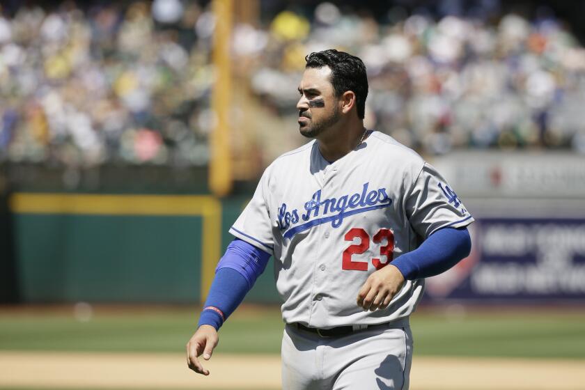 Dodgers first baseman Adrian Gonzalez. shown in a game in Oakland on Aug. 19, was forced out of a game Thursday against the Cincinnati Reds after suffering a bruised right knee.