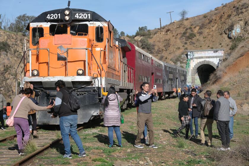 People venture outside the train during a stop at the Abelardo L. Rodriguez dam during the Tren Turstico Tijuana-Tecate tourist train ride on January 27, 2024, in Tijuana, Mexico. The recently reactivated train ride takes people in two passenger train coaches from Tijuana to Tecate and back, with a four hour stop in Tecate. The excursion was the second time after the inaugural ride in December 2023. January 27, 2024 Tijuana, Mexico Photo - David Maung