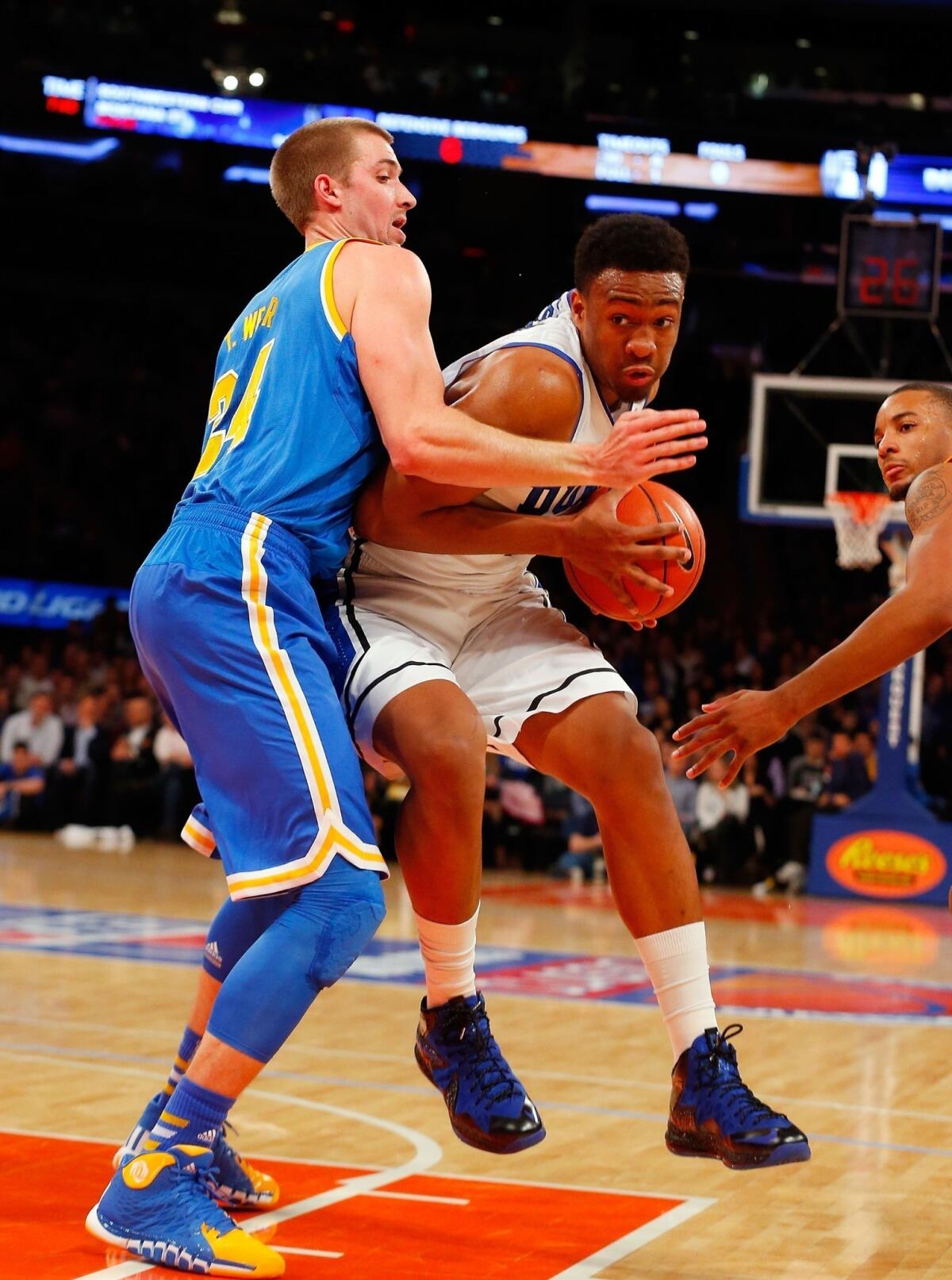 Duke's Jabari Parker, right, drives to the basket on UCLA's Travis Wear during the Bruins' 80-63 loss Thursday at Madison Square Garden in New York.
