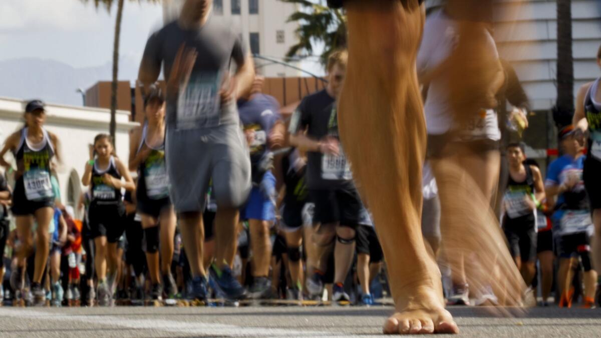 Runners make their way down Santa Monica Boulevard in Beverly Hills during the L.A. Marathon on March 18.