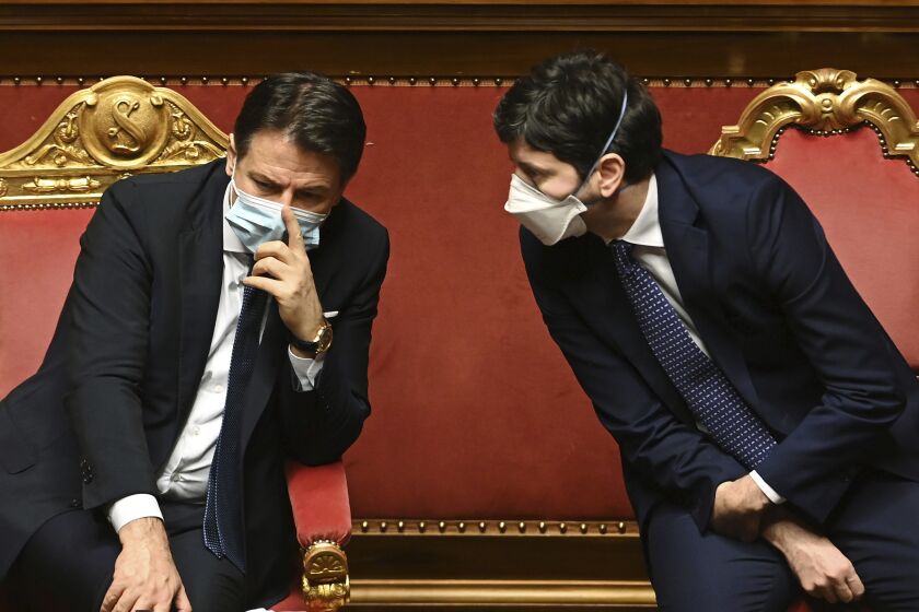FILE - Then Premier Giuseppe Conte, left, talks with Health Minister Roberto Speranza at the Senate, in Rome, on Jan. 19, 2021. The Court of Ministers in Brescia on Wednesday, June 7, 2023, threw out the case against ex-Premier Giuseppe Conte and ex-Health Minister Roberto Speranza, alleging they failed to extend the lockdown to Bergamo and adjacent valleys in the early days of the pandemic, causing unwarranted deaths. Both officials have said they acted according to scientific knowledge and expert opinion available at the time. Conte told RAI state TV that the decision “comforts me.” (Andreas Solaro/Pool via AP)