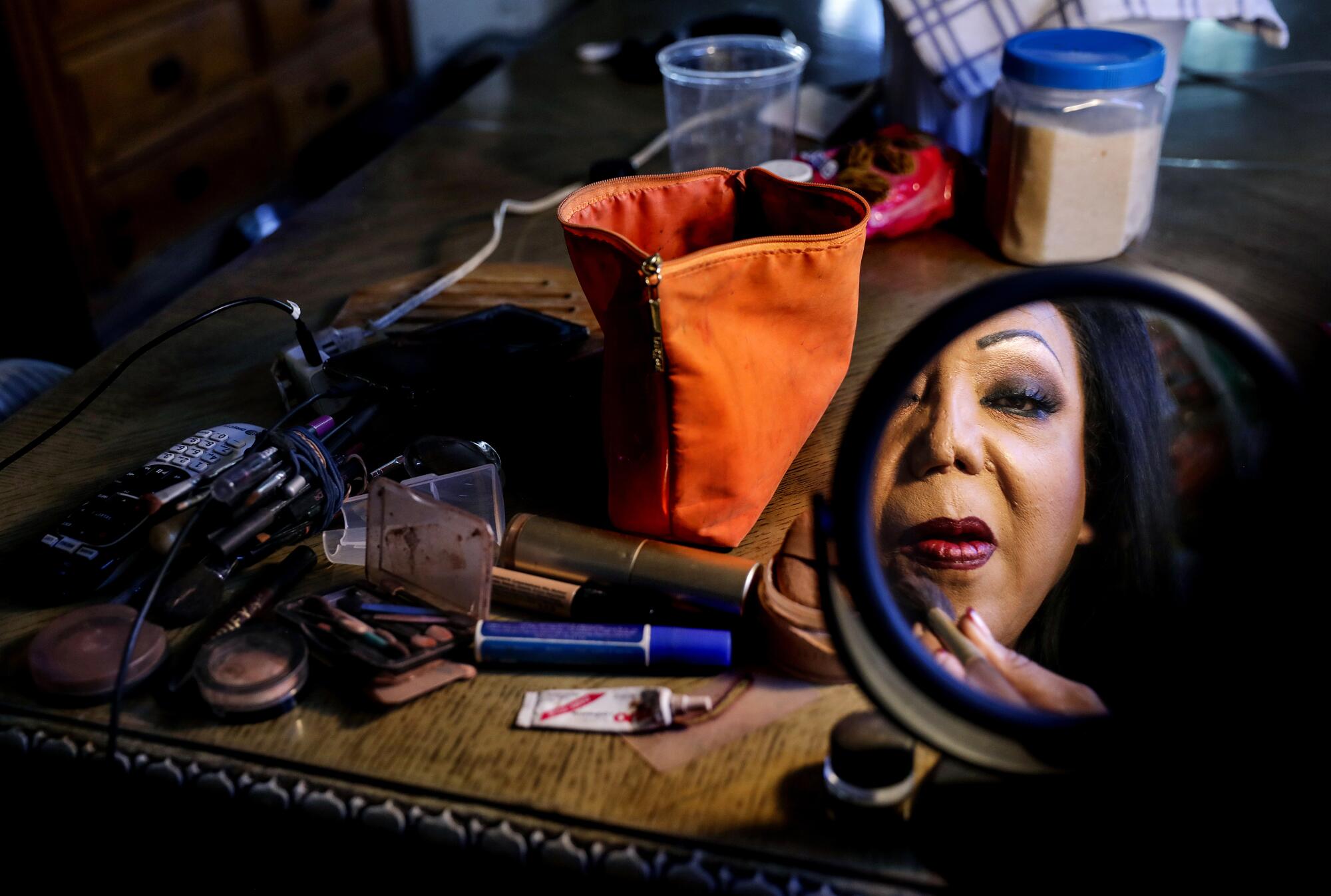 Marimar, a transgender woman infected with the coronavirus, does her makeup