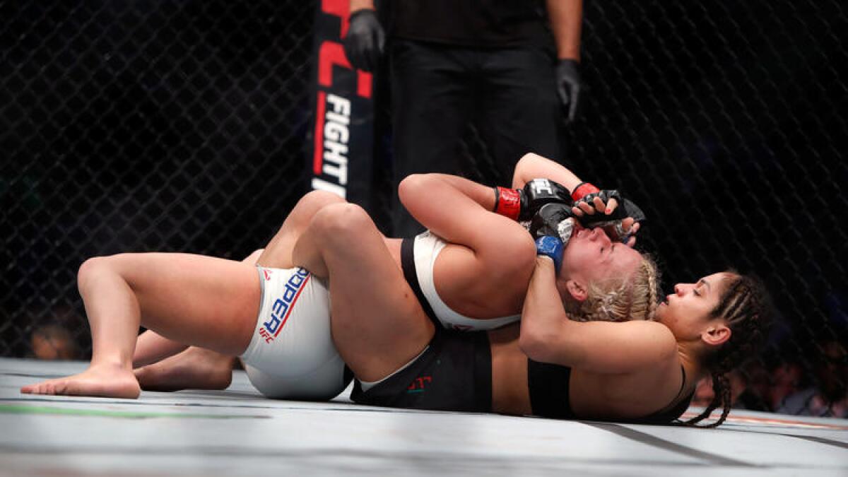 Cynthia Calvillo secures the choke hold against Amanda Cooper during their bout at UFC 209.