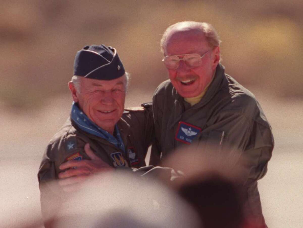 Chuck Yeager greets fellow pilot Bob Hoover, right, in 1997.