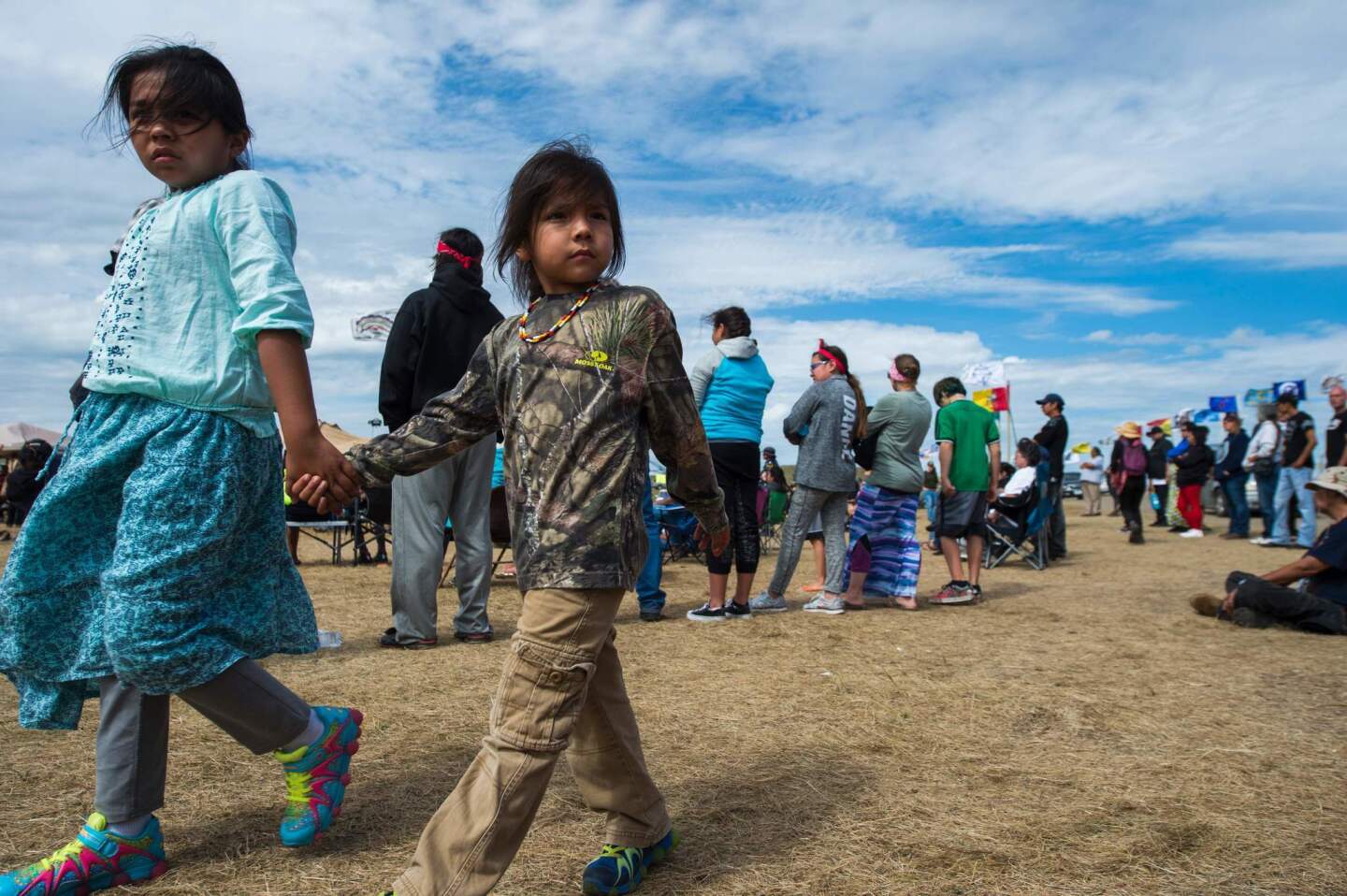 Two children walk together in an oil pipeline protest encampment near Cannon Ball, N.D., where members of a Native American tribe and their supporters have gathered to voice their opposition to the Dakota Access Pipeline.