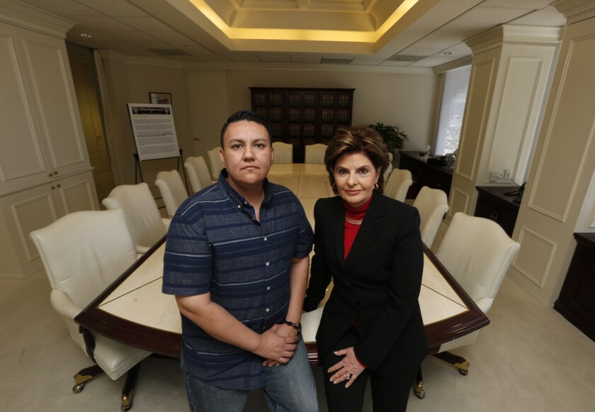 Rose Trevis, left, a transgender man whose lawsuit said he was denied a haircut at Hawleywood’s Barber Shop & Shaving Parlor, poses with his attorney, Gloria Allred.