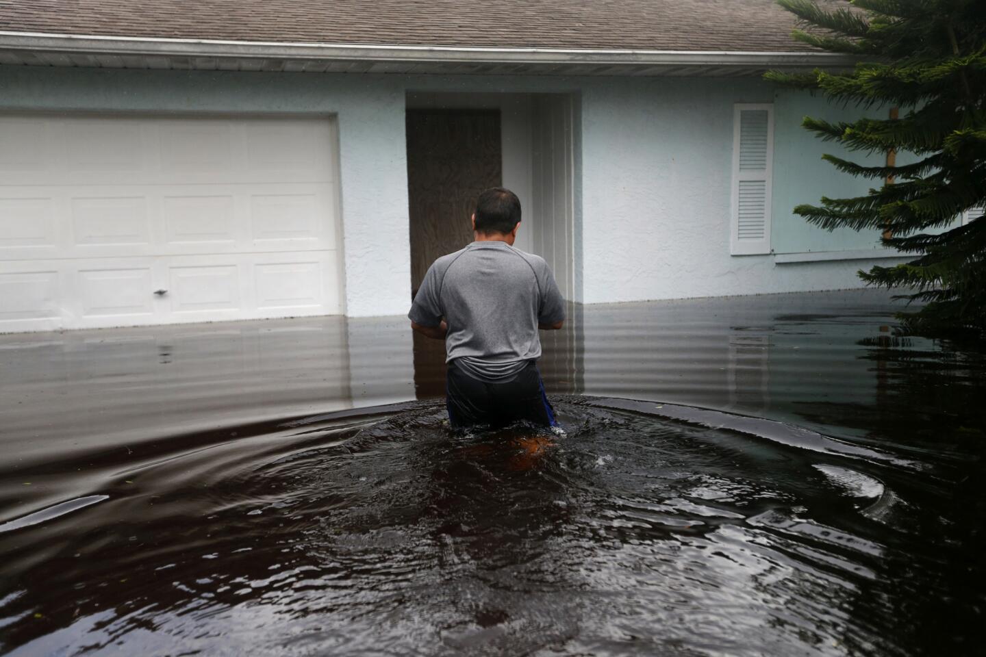 A man returns to his flooded home in the aftermath of Hurricane Irma in Bonita Springs, Fla., on Sept. 11, 2017.