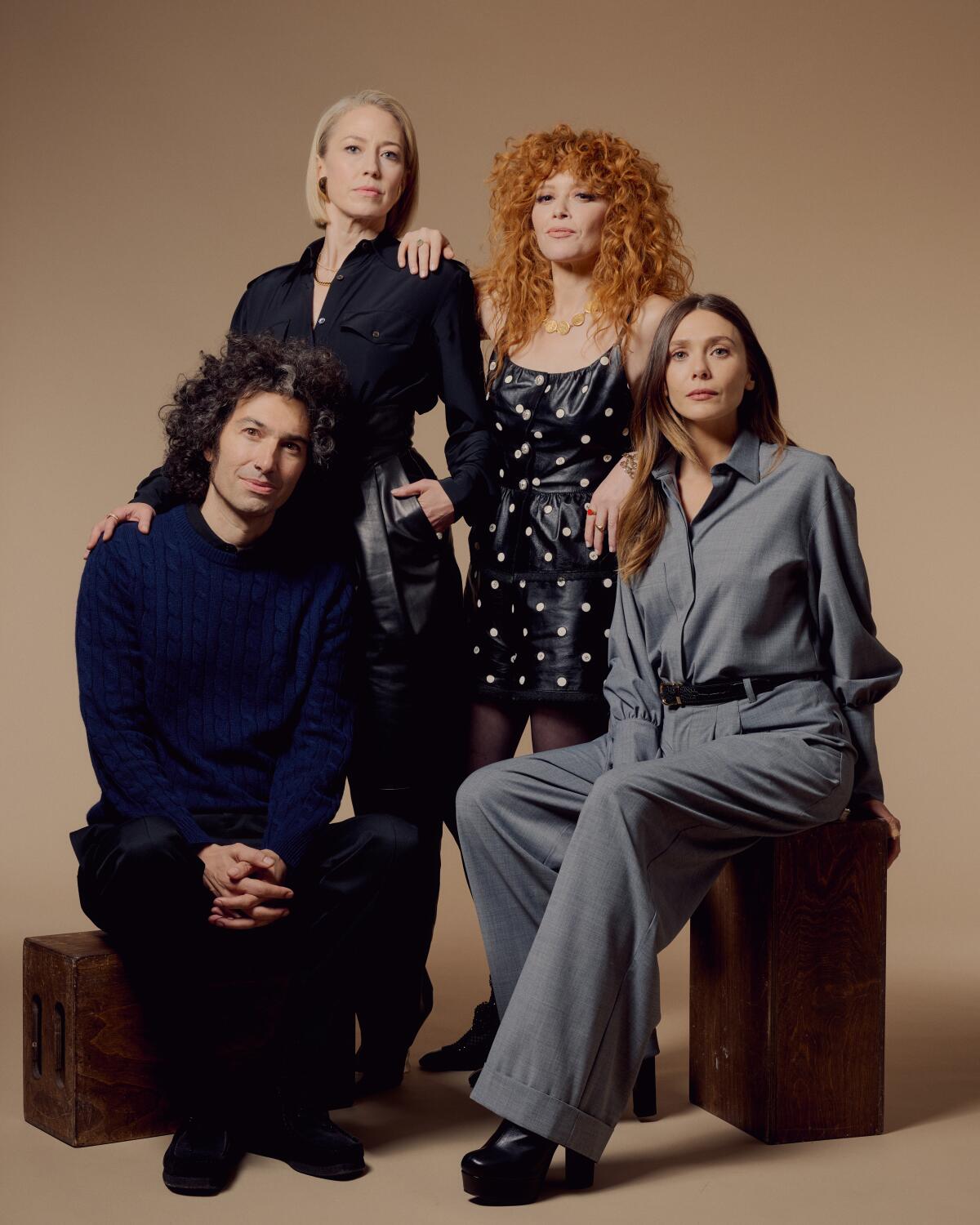 Three women and their director pose for a group shot.