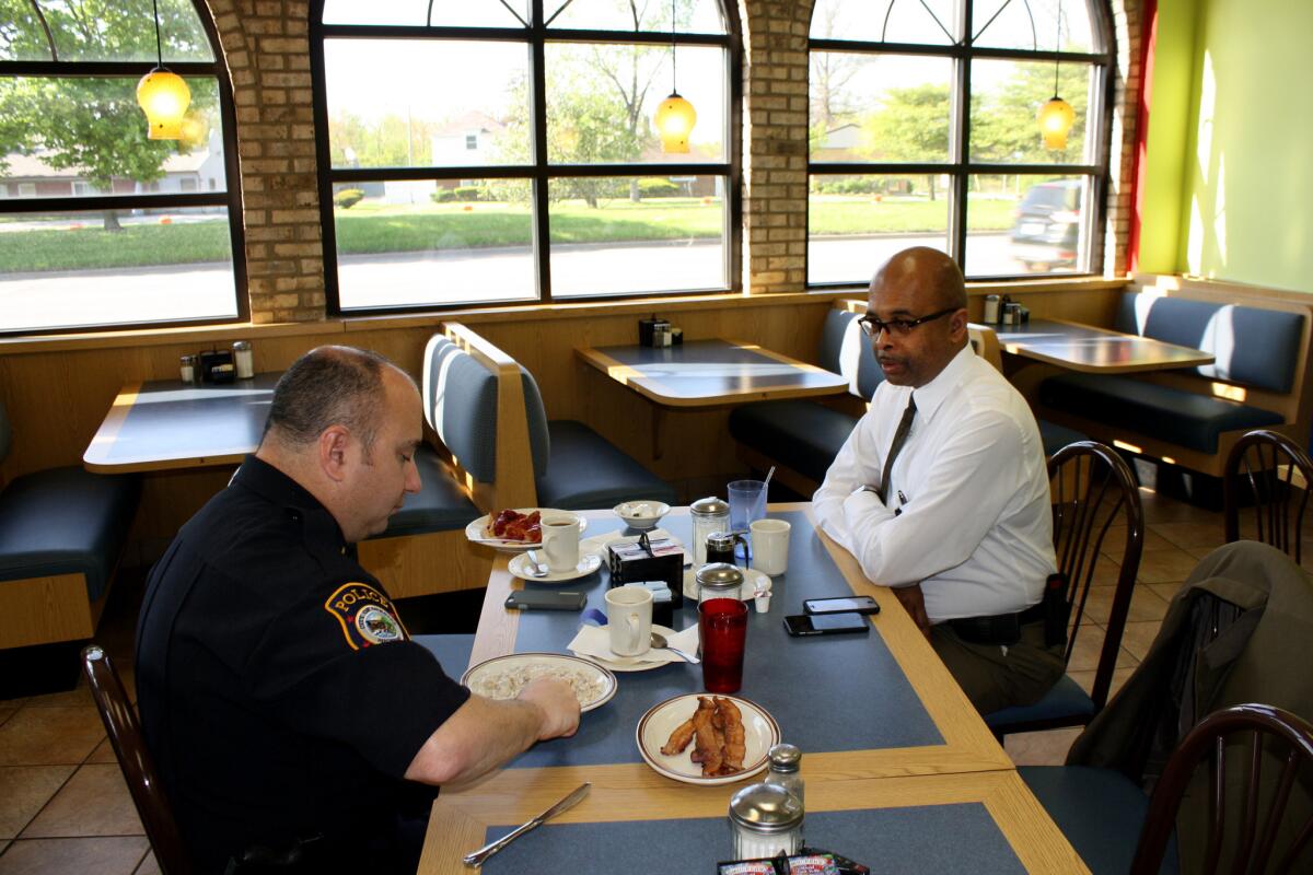 Riley eats at Applewood Coney Island, a local diner, with Lt. Jeff Twardzik, who oversees patrol operations in Inkster. (Jaweed Kaleem / Los Angeles Times)