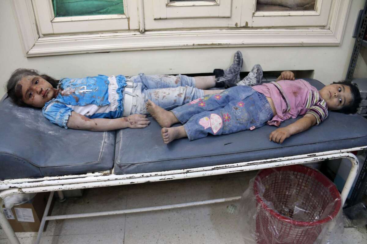 Injured children wait for treatment after reported shelling in the northern Syrian city of Aleppo on May 21, where government forces the following day broke a long-standing rebel blockade around a prison.