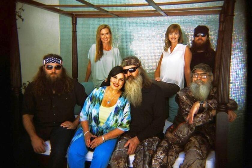 "Duck Dynasty" on A&E features Willie, left, his wife, Korie, matriarch Kay and her husband, Phil, Missy and her husband, Jase (background) and Si.