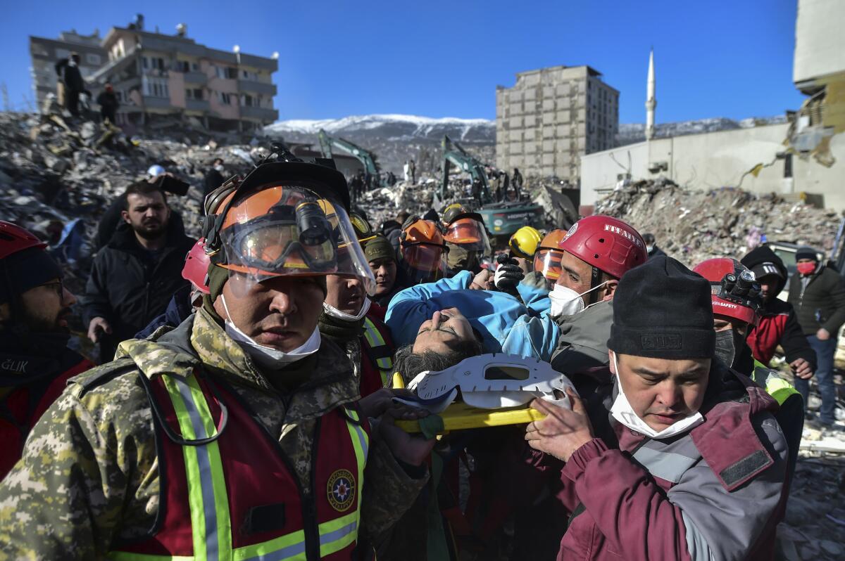 Rescue workers pulling out an earthquake survivor from collapsed building