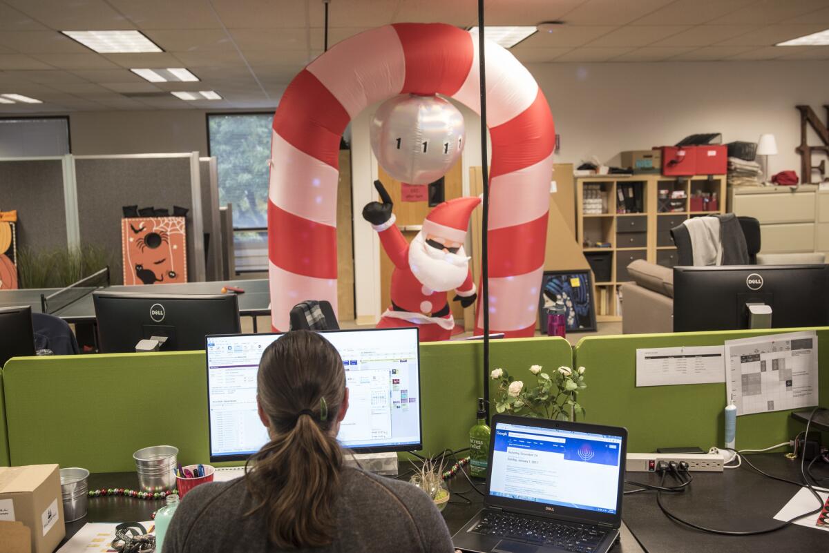 Amid year-round Christmas decorations, an employee of Balsam Hill works at the company's Redwood City headquarters.
