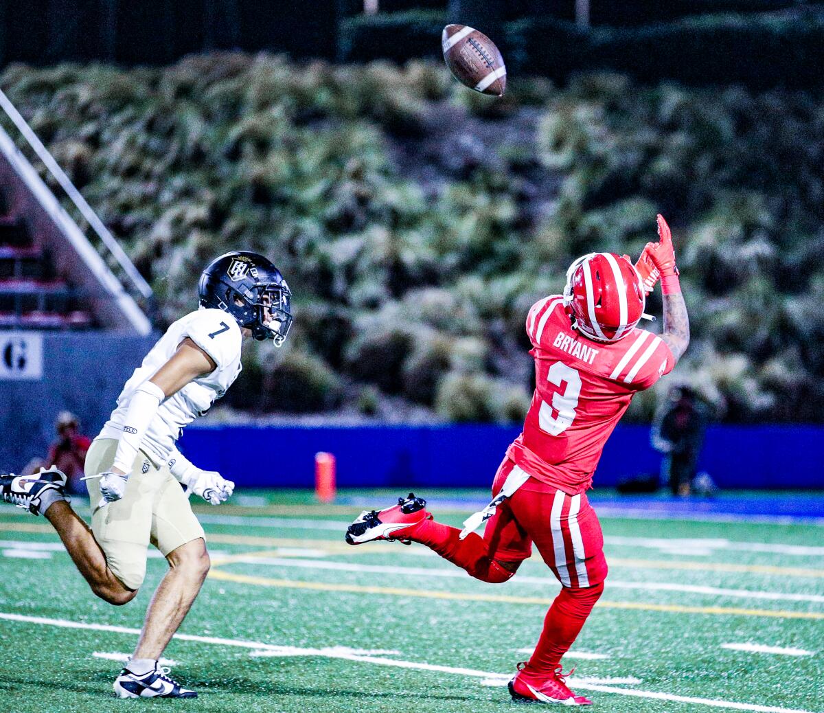 Ajon Bryant of Mater Dei makes a 40-yard reception against Servite's Sax Churchwell on Friday night.