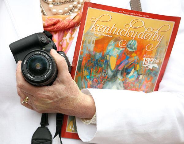 A detail of a fan holding a officing racing program and a camera during the 137th Kentucky Derby at Churchill Downs on May 7, 2011 in Louisville, Kentucky.