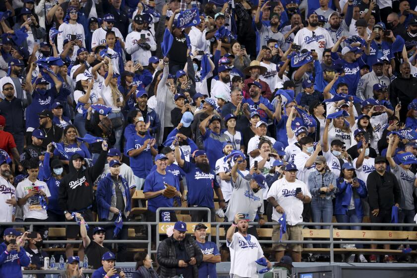 Los Angeles, CA - October 19: Fans cheer in the stands during the ninth inning in game three in the 2021 National League Championship Series between the Atlanta Braves and Los Angeles Dodgers at Dodger Stadium on Tuesday, Oct. 19, 2021 in Los Angeles, CA. The Dodgers won 6-5. (Robert Gauthier / Los Angeles Times)