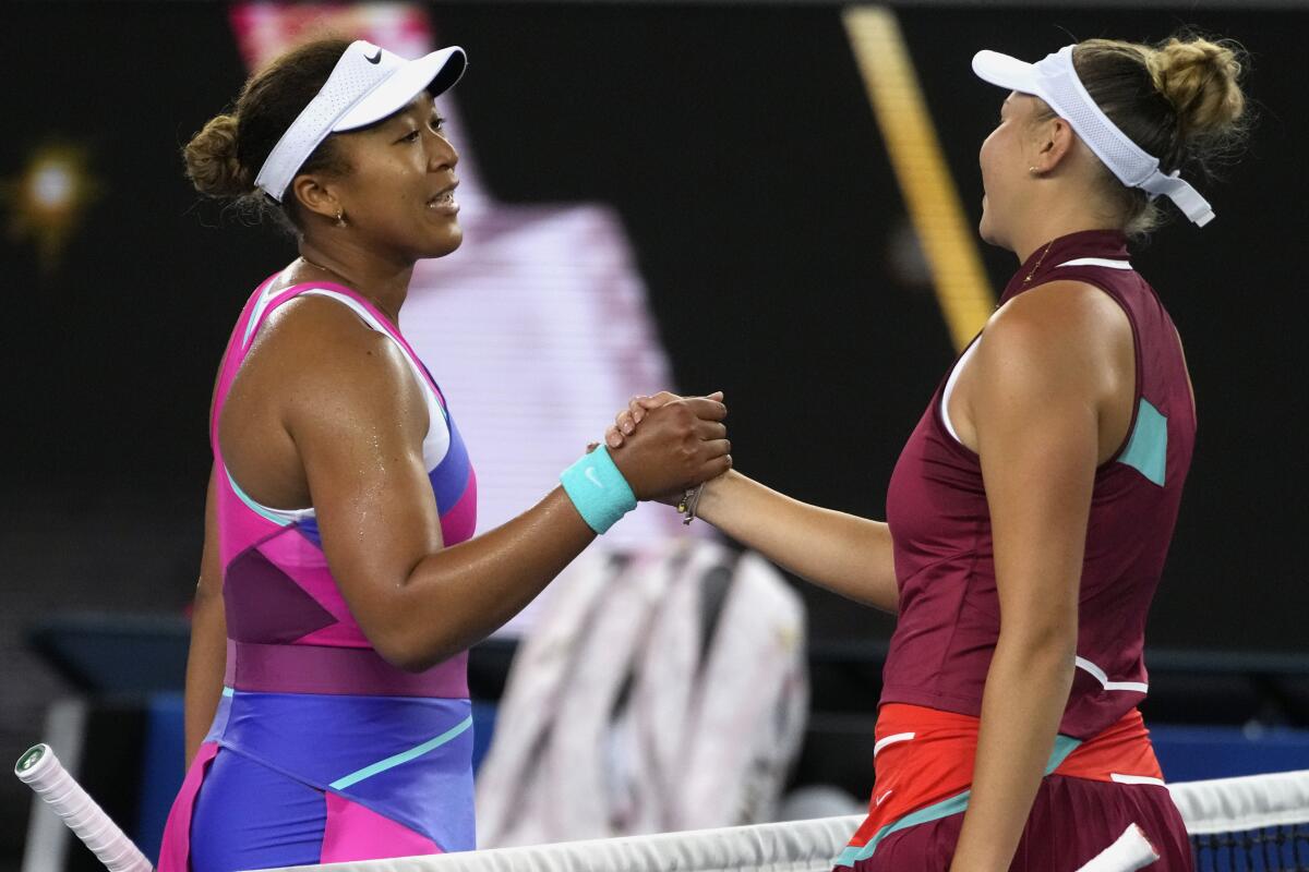 FILE - Naomi Osaka, left, of Japan, congratulates Amanda Anisimova of the U.S. after their third round match at the Australian Open tennis championships in Melbourne, Australia, Friday, Jan. 21, 2022. Naomi Osaka’s return to the French Open will be a tough test against the player who beat her at the Australian Open, No. 27 Amanda Anisimova. (AP Photo/Simon Baker, File)