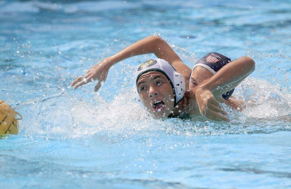 Costa Mesa Aquatics Club's Teak Zachary, left, chases down a loose ball after stealing it away from Los Angeles Water Polo Club's Adam McDonald, right, during a USA Junior Olympics semifinal match at Mater Dei High in Santa Ana on Tuesday.