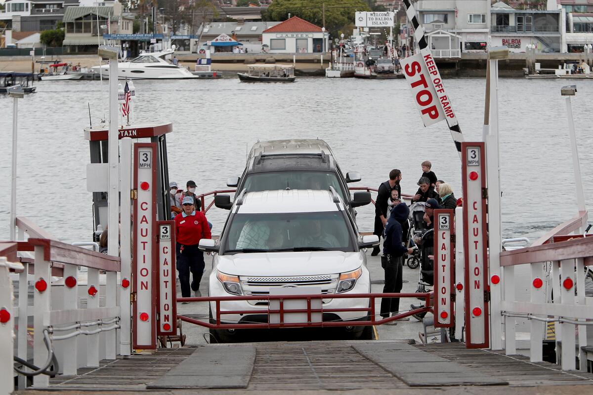 Vehicles and pedestrians prepare to disembark from the Balboa Island Ferry in 2022.