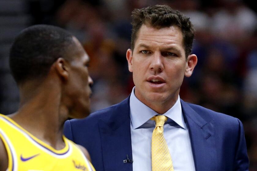 Los Angeles Lakers coach Luke Walton speaks with guard Rajon Rondo during the first half of the team's NBA basketball game against the Utah Jazz on Wednesday, March 27, 2019, in Salt Lake City. (AP Photo/Rick Bowmer)
